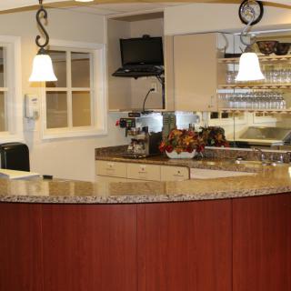 A modern reception desk with overhead lighting and a welcoming design.