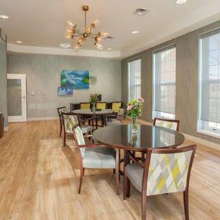 A stylish dining room with contemporary decor and large windows.