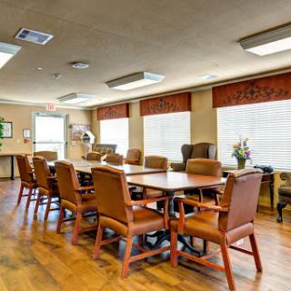 A spacious conference room equipped with a large table and comfortable chairs, ideal for meetings and discussions.