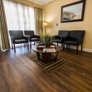A cozy waiting room with comfortable chairs and a small coffee table, creating an inviting atmosphere.