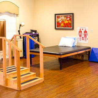 A clean and organized physical therapy room equipped for rehabilitation exercises.
