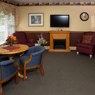 A cozy living room with a television and fireplace, perfect for relaxation.