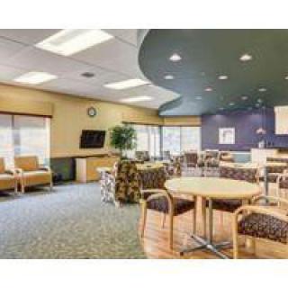 A modern waiting room with comfortable seating and a TV.