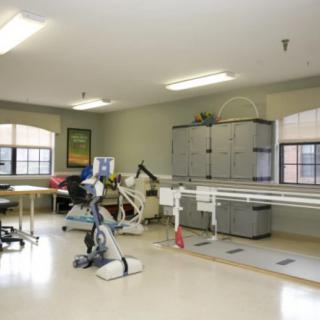 A rehabilitation room equipped with exercise machines and therapy equipment.