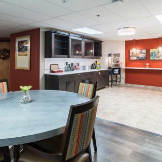 A modern kitchen and dining area with stylish furniture and cabinetry.
