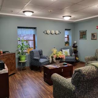 A cozy living room with comfortable seating arrangements, indoor plants, and elegant decor.