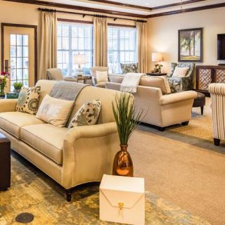 A cozy and well-decorated living room with elegant furnishings and soft lighting.