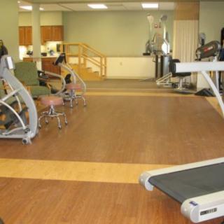 A spacious gym with various exercise equipment, including treadmills and weight machines.