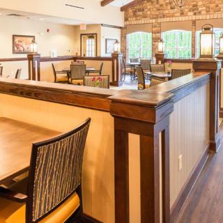 A cozy restaurant interior with wooden furniture and warm lighting.