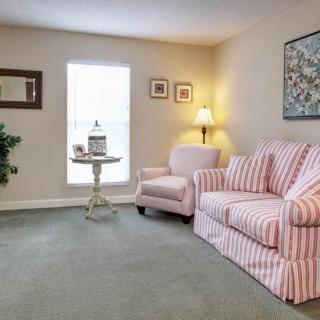 A cozy living room with striped furniture and soft lighting.