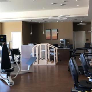 A spacious gym equipped with various exercise machines.