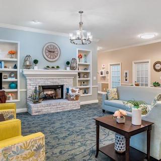 A cozy living room with a fireplace and comfortable seating.