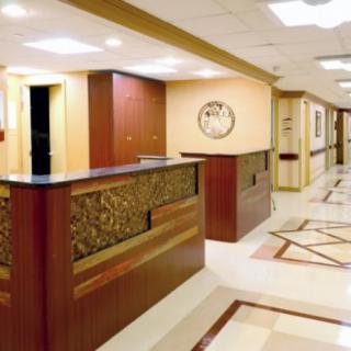 A modern reception area with wooden decor and a well-lit hallway.