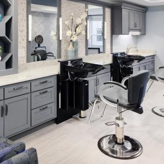 A modern hair salon with stylish barber chairs and sleek interior design.