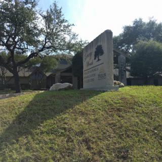 A welcoming sign marking the entrance to a park.