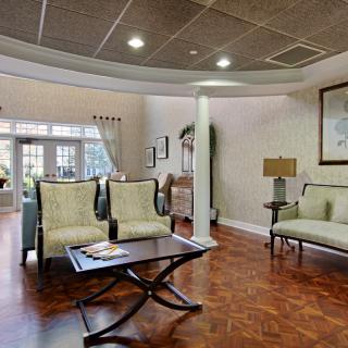 A modern living room with elegant seating and wood flooring.