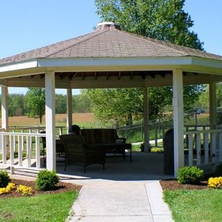 A charming gazebo situated in a serene garden setting.