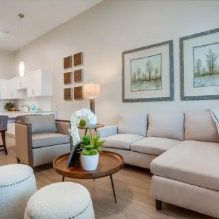 A modern living room with comfortable seating, stylish decor, and soft lighting.