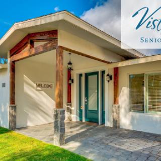 A beautifully designed home featuring a welcoming entrance and well-maintained landscaping.