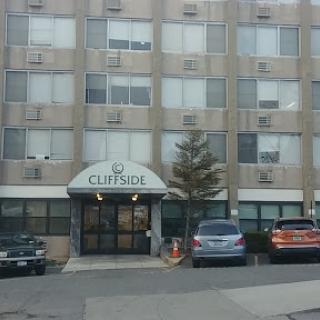 The Curbside Hotel with parked cars in front.