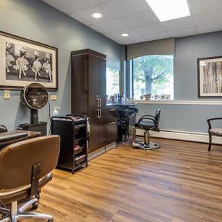A modern hair salon interior with chairs, mirrors, and stylish decor.