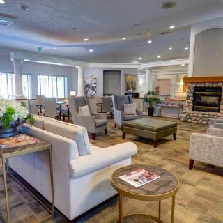 A spacious and modern living room featuring plush seating, a fireplace, and stylish decor.
