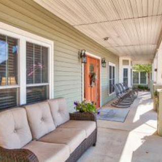 A cozy porch with comfortable seating and decorative elements.