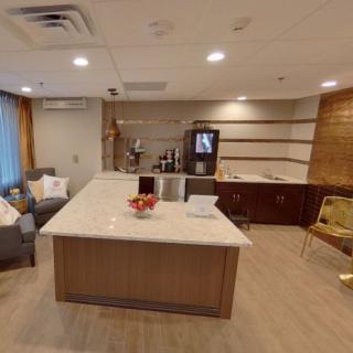 A modern reception area with comfortable seating and a refreshment station.