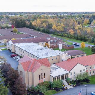 Aerial view of a campus with surrounding autumn trees.