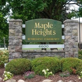 Entrance sign for Maple Heights Retirement Community surrounded by landscaping.