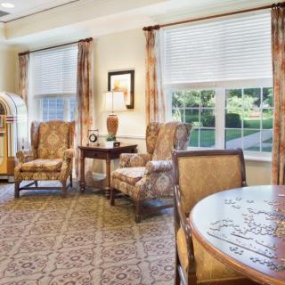 A cozy living room with comfortable seating and a jukebox.