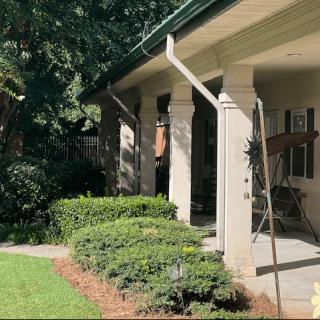A well-maintained house with a landscaped front yard and porch.