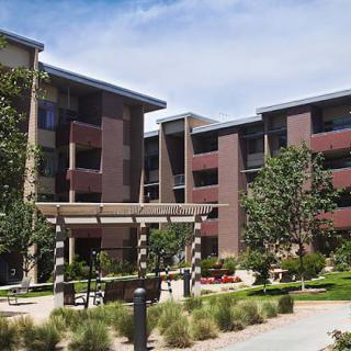 A modern residential apartment complex with landscaped outdoor areas.