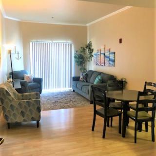 A cozy living and dining area with comfortable seating, a dining table, and tasteful decor.