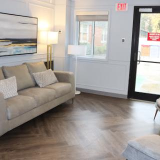A cozy living room area featuring a comfortable sofa, contemporary art, and stylish lighting.