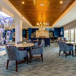 A modern restaurant interior with elegant seating and warm lighting.