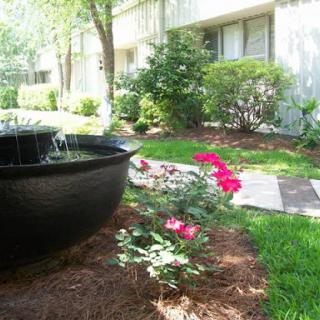 A serene garden showcasing vibrant flowers and a peaceful fountain.