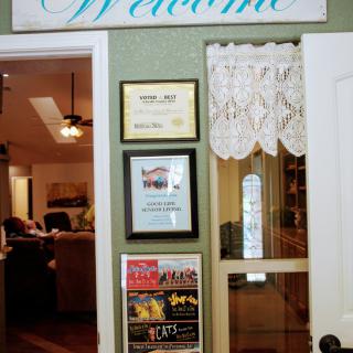 A welcoming entryway adorned with certificates and plaques.