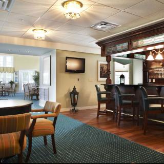 Cozy lounge area with a small bar and comfortable seating.