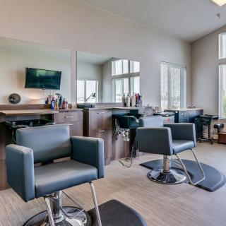 Modern salon interior with styling chairs and mirrors.