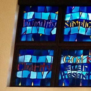 A stained glass window featuring blue hues and abstract designs.