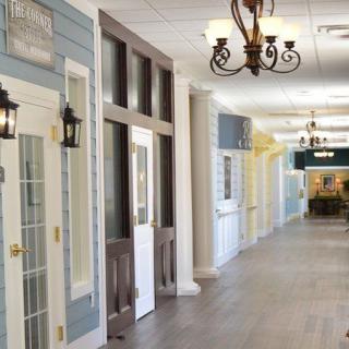 A well-lit hallway with decorative lighting and multiple doors.