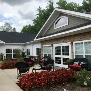A welcoming outdoor seating area surrounded by vibrant flowers, perfect for relaxation.