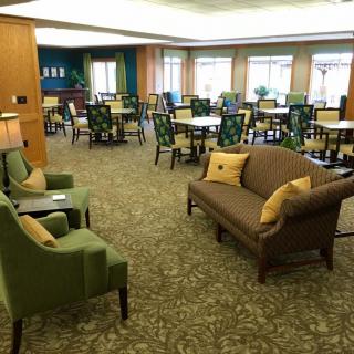 A cozy lounge area with comfortable seating and tables.