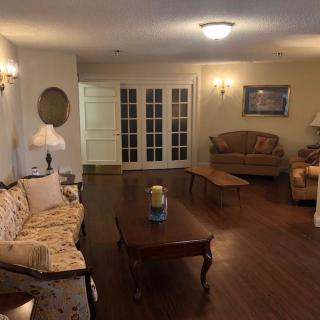 A cozy living room with classic furniture and hardwood flooring.