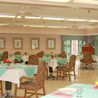 An empty dining room with neatly arranged tables and chairs.