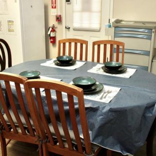 A dining table set with plates and utensils for four people.