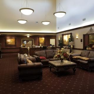 A cozy lobby area with comfortable seating and warm lighting, inviting relaxation and conversation.