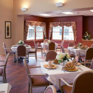 A cozy dining area set with neatly arranged tables and chairs, ready for guests.