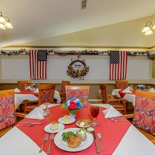 A festive dining area adorned with American flags and elegant table settings.